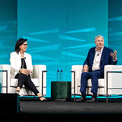 A man and a woman sitting on a bench.