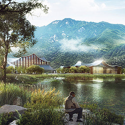 A person sitting on a bench by a lake with mountains in the background.