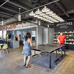 Travel technology client workplace with ping pong table and cafe