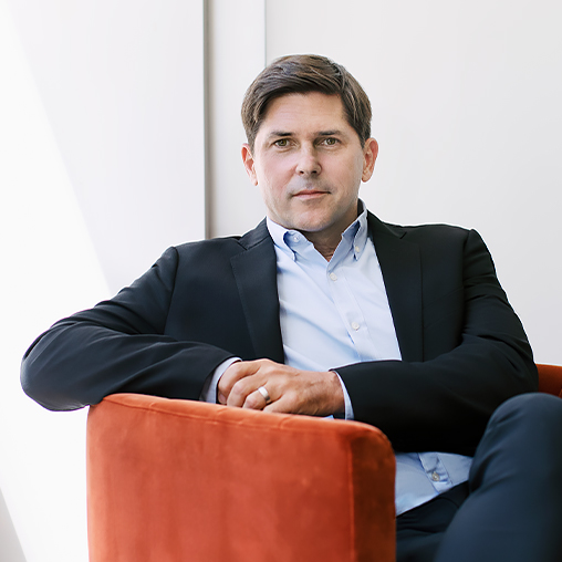 Benjy Ward from Gensler Chicago sitting in a burnt orange velvet chair
