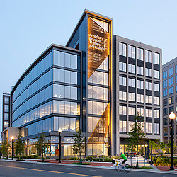 A building with a street and trees.