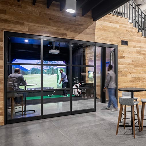 Loffler Companies breakout room with golf simulator