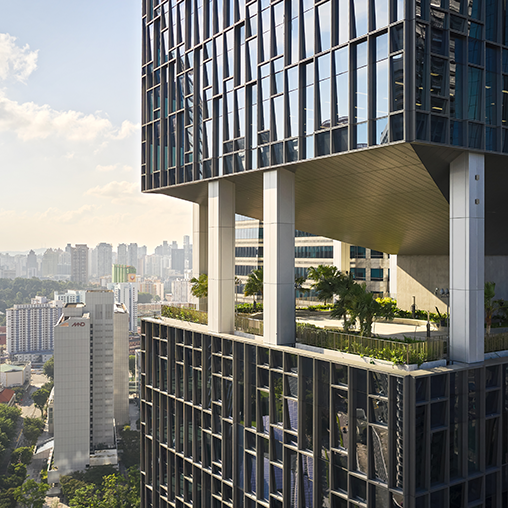 A building with a view of a city and trees.
