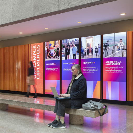 Syracuse University hallway with digital screens