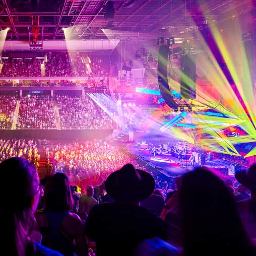 A crowd of people inside the immersive stadium experience at Moody Center.