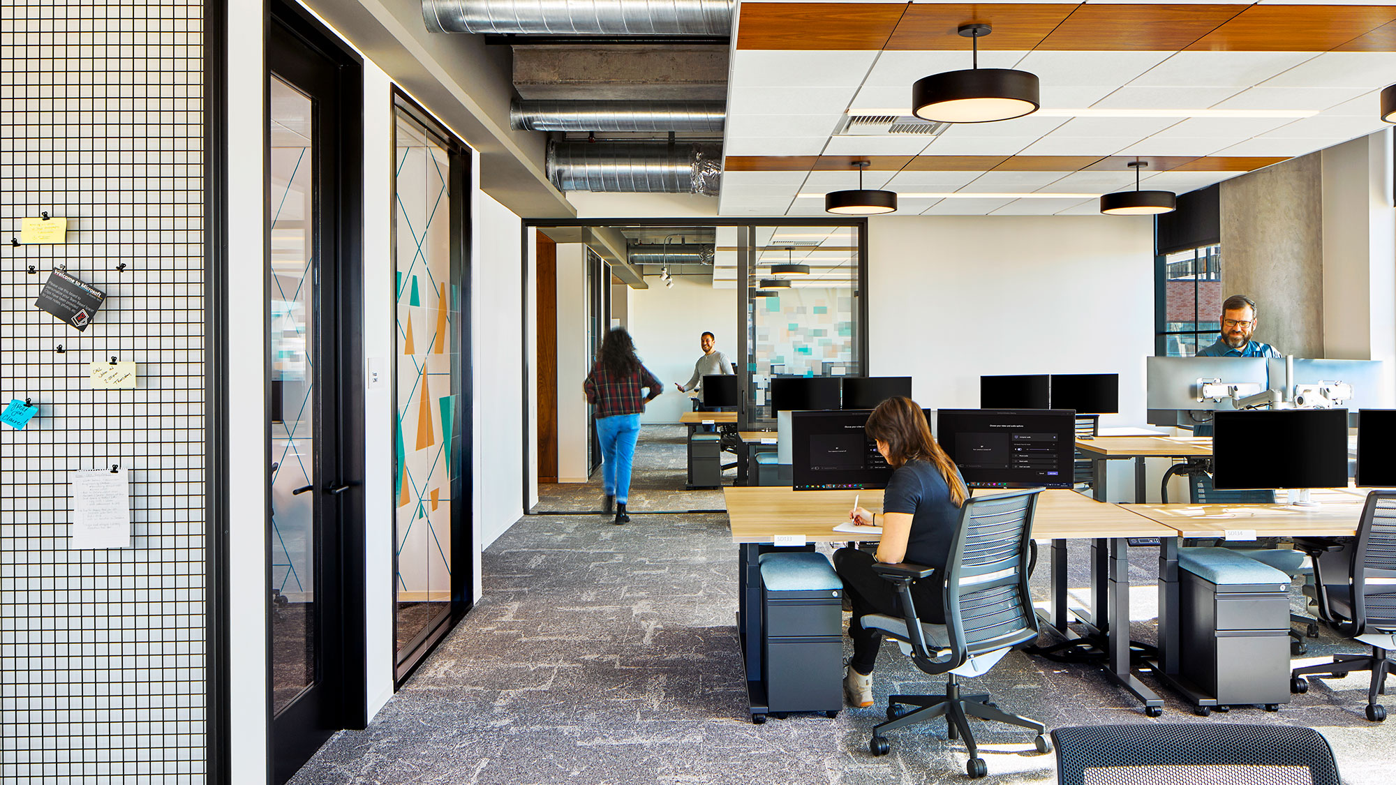 A person sitting at a desk in an office.