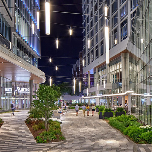 A walkway between buildings with people walking.