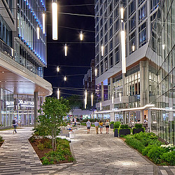 A walkway between buildings with people walking.
