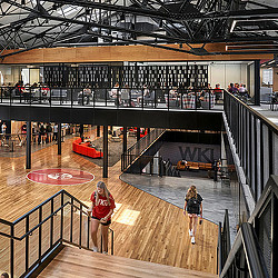 People walking on a wooden deck.