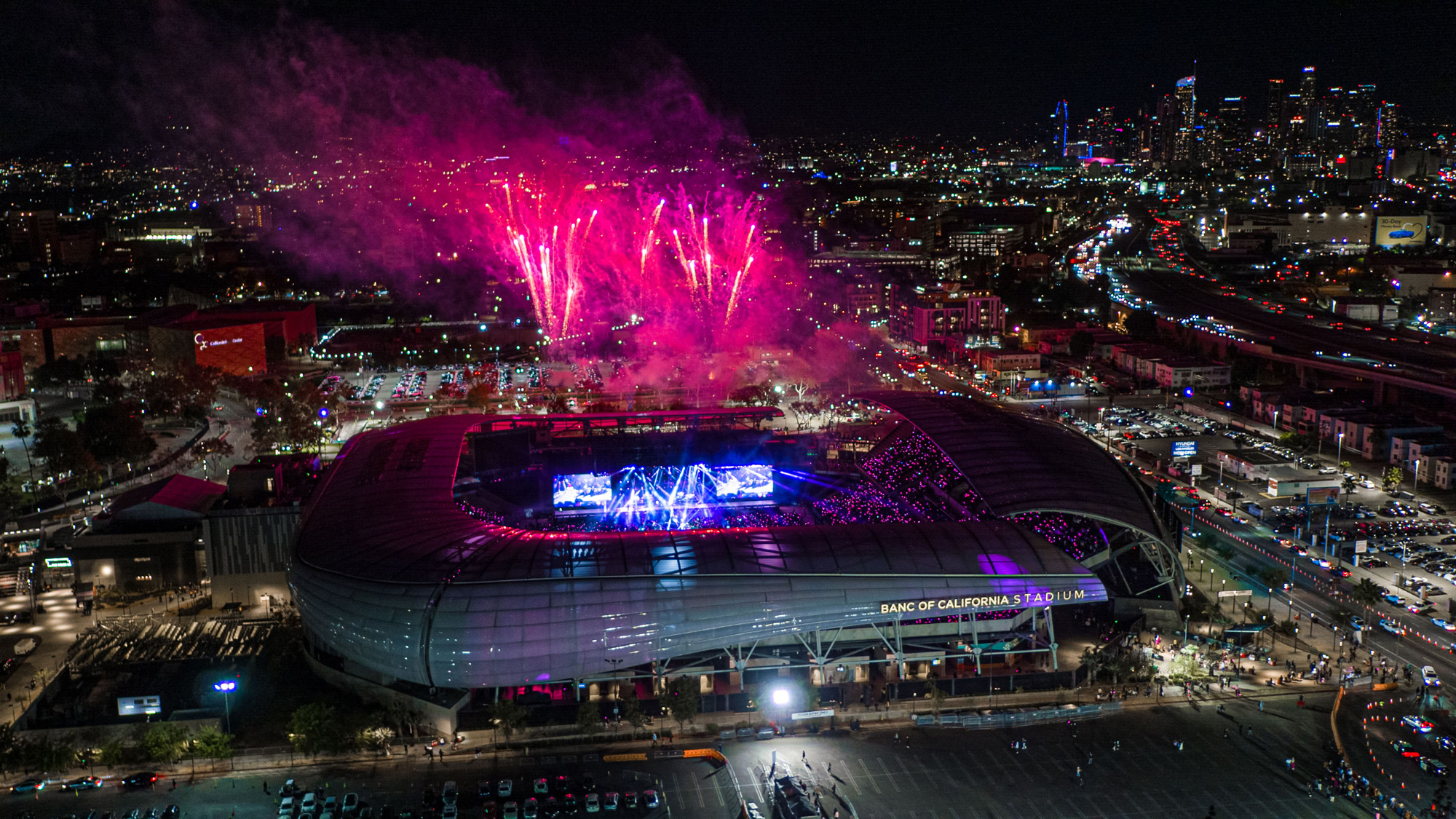 A stadium with fireworks in the sky.