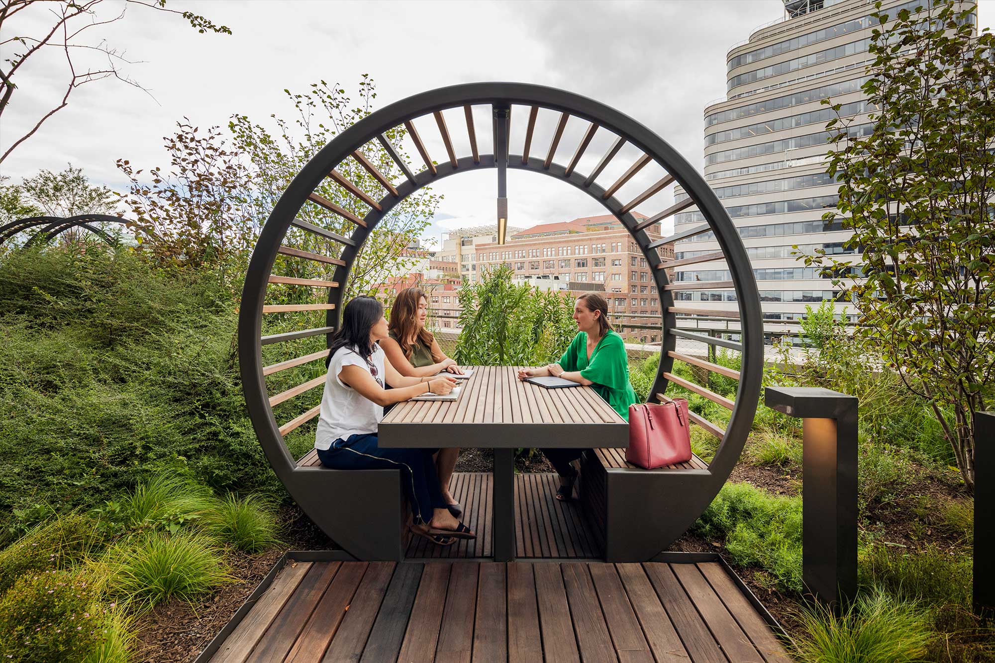 3 women meeting in an outdoor booth on the High Line