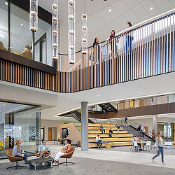 People sitting on benches in a building.