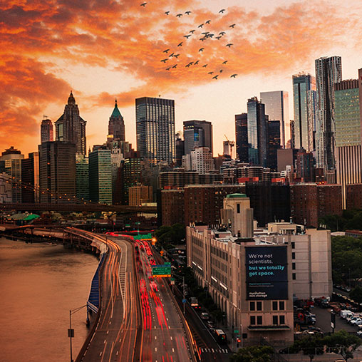 A city skyline with a train passing by.