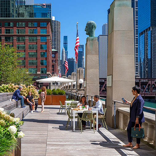 People sitting at tables outside.