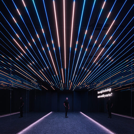A man standing in the middle of Verizon Innovation Center, San Francisco digital passageway