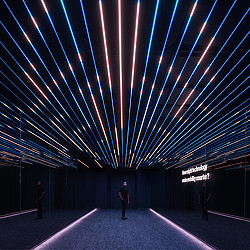 A man standing in the middle of Verizon Innovation Center, San Francisco digital passageway