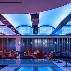 A pool with chairs and tables.