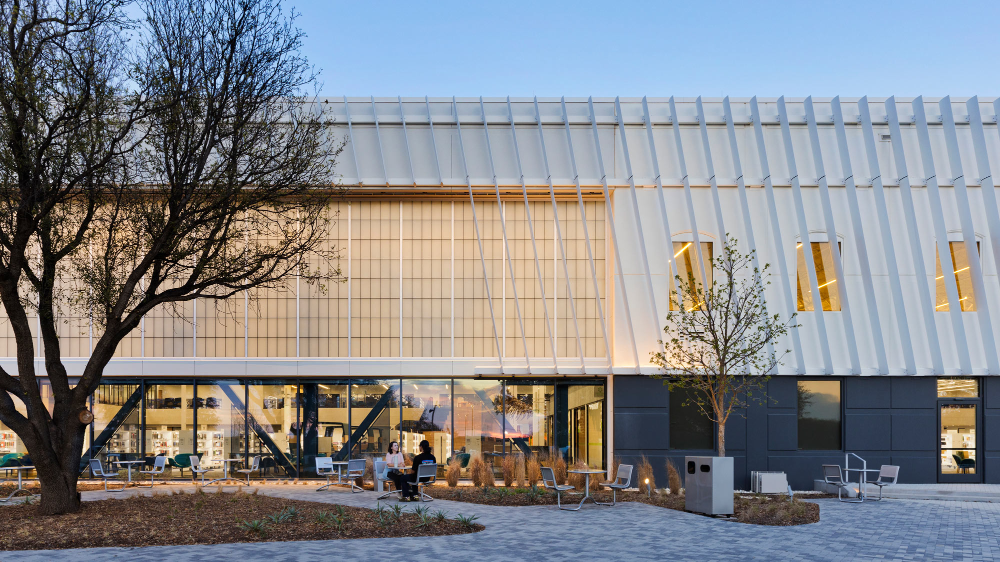 A building with a few people sitting outside.