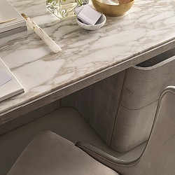 A white counter top with a silver bar on it.