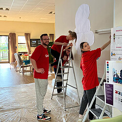 Gensler Birmingham office members painting mural at Birmingham Hospice