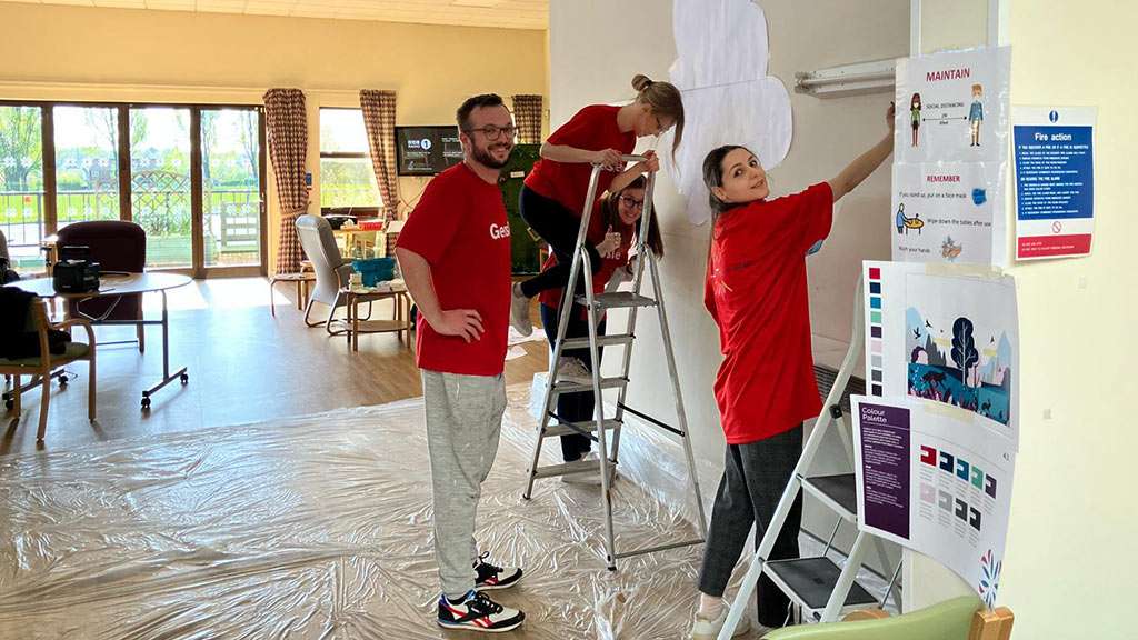 Gensler Birmingham office members painting mural at Birmingham Hospice