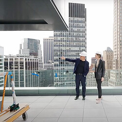 2 people touring Pearl House NYC terrace under construction