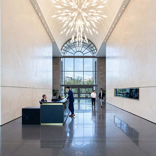 A group of people in a large room with a large glass ceiling.