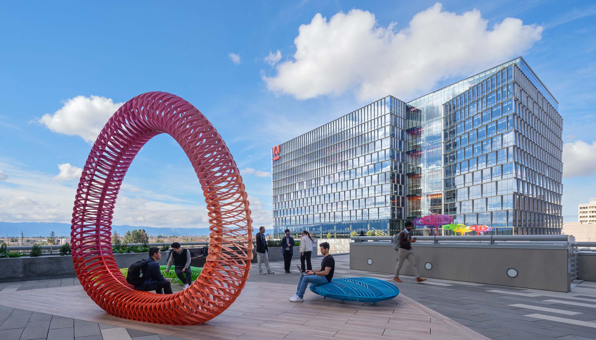 A large red sculpture in front of a building.