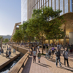 A group of people walking on a sidewalk next to a building.