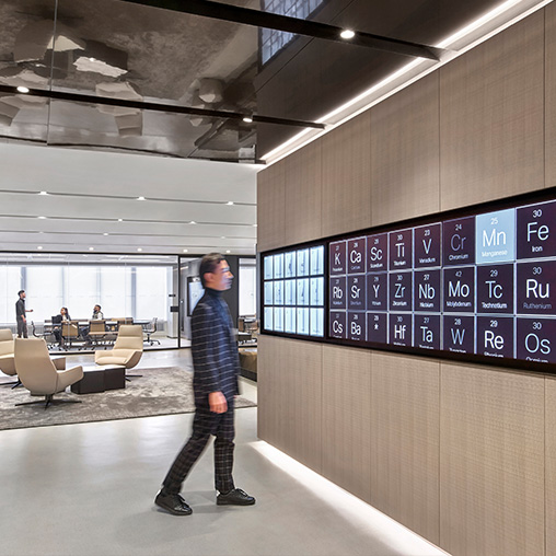 Man looking at Traxys Headquarters digital screen