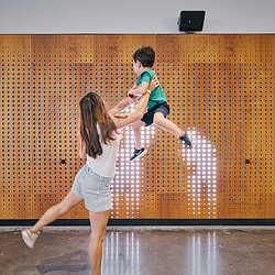 A boy and girl jumping in the air.