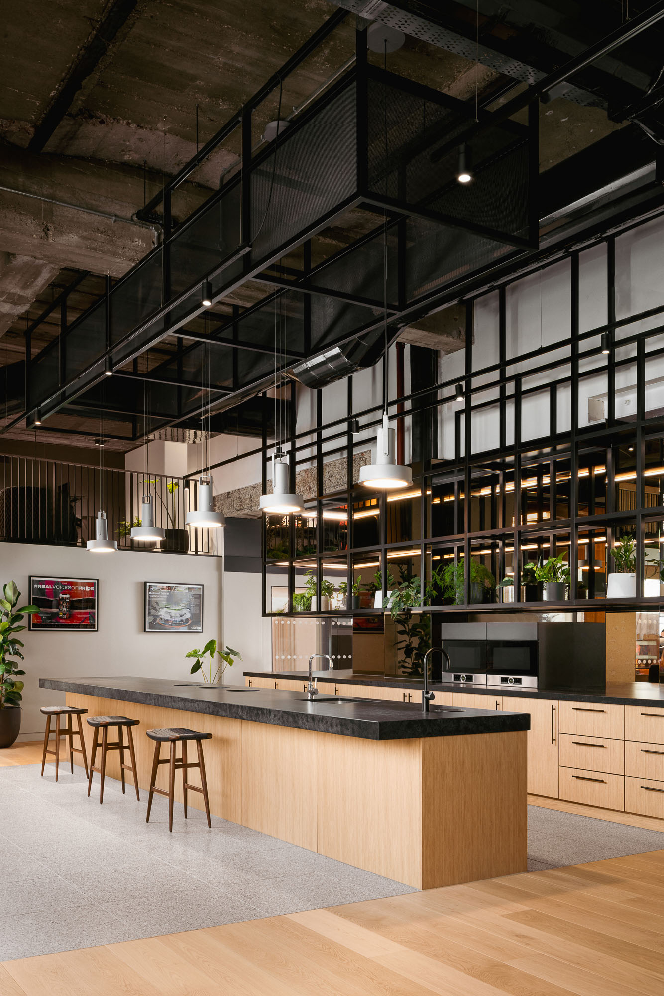 A kitchen with a bar and stools.