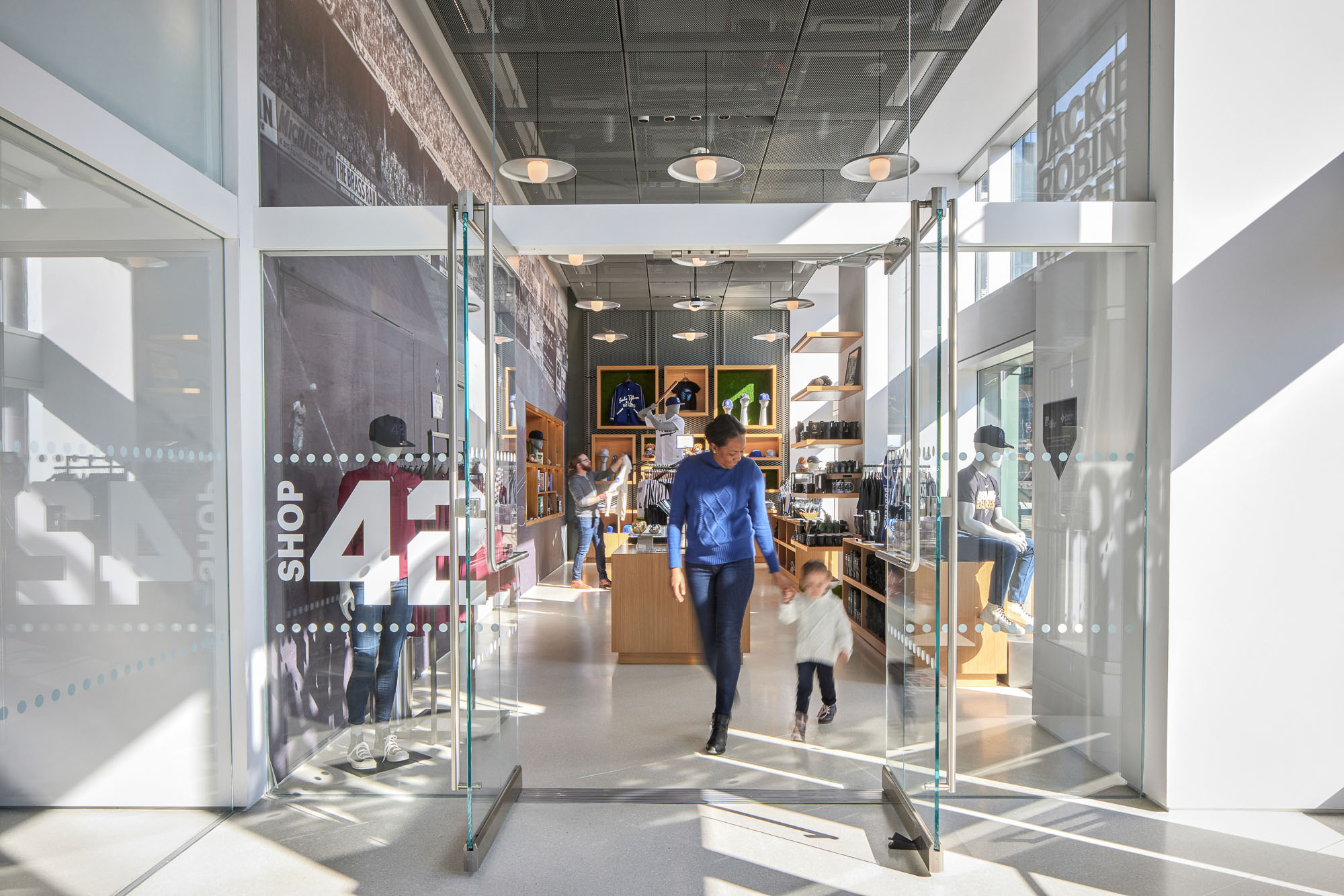 A man and a child walking through a mall.