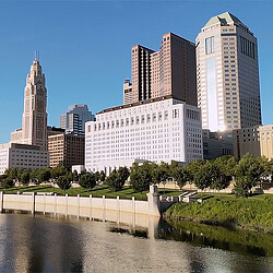 Cityscape of Columbus, Ohio with buildings at edge of river.