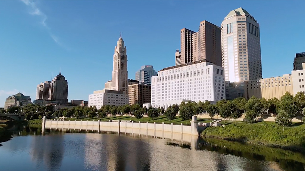 Cityscape of Columbus, Ohio with buildings at edge of river.
