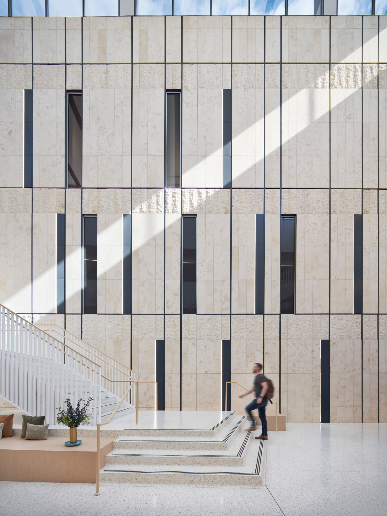 A person standing on the steps of a building.