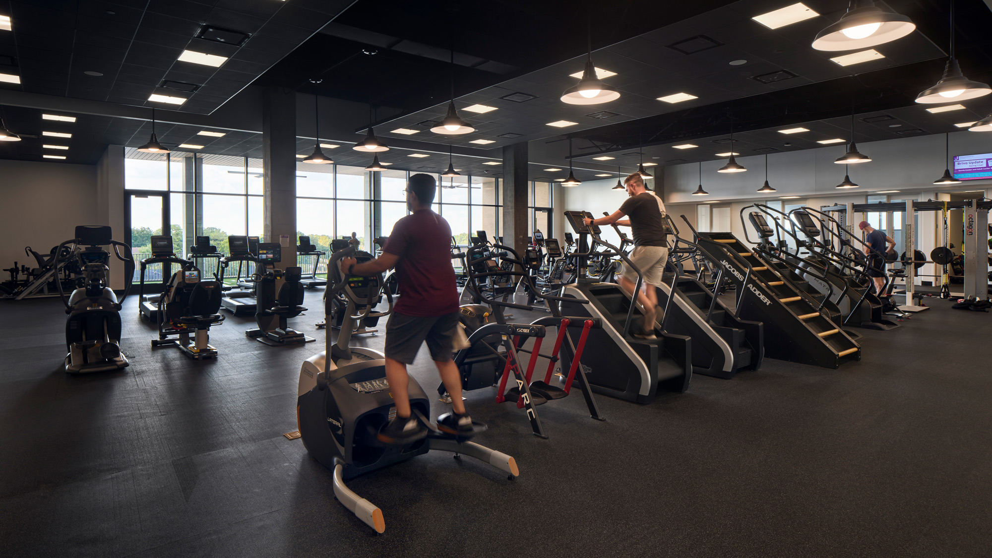 A couple of men exercising in a gym.