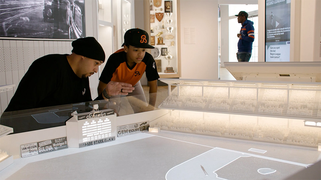 Father and son viewing Jackie Robinson Museum display