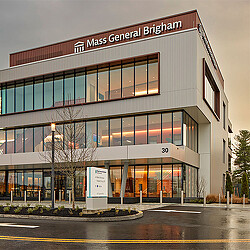 A building with a sign in front.