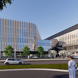 A person walking outside of UT Tyler's cutting-edge medical educational building.