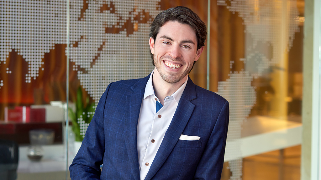 A man in a suit smiling.