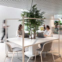 A group of people sitting at a table with laptops.