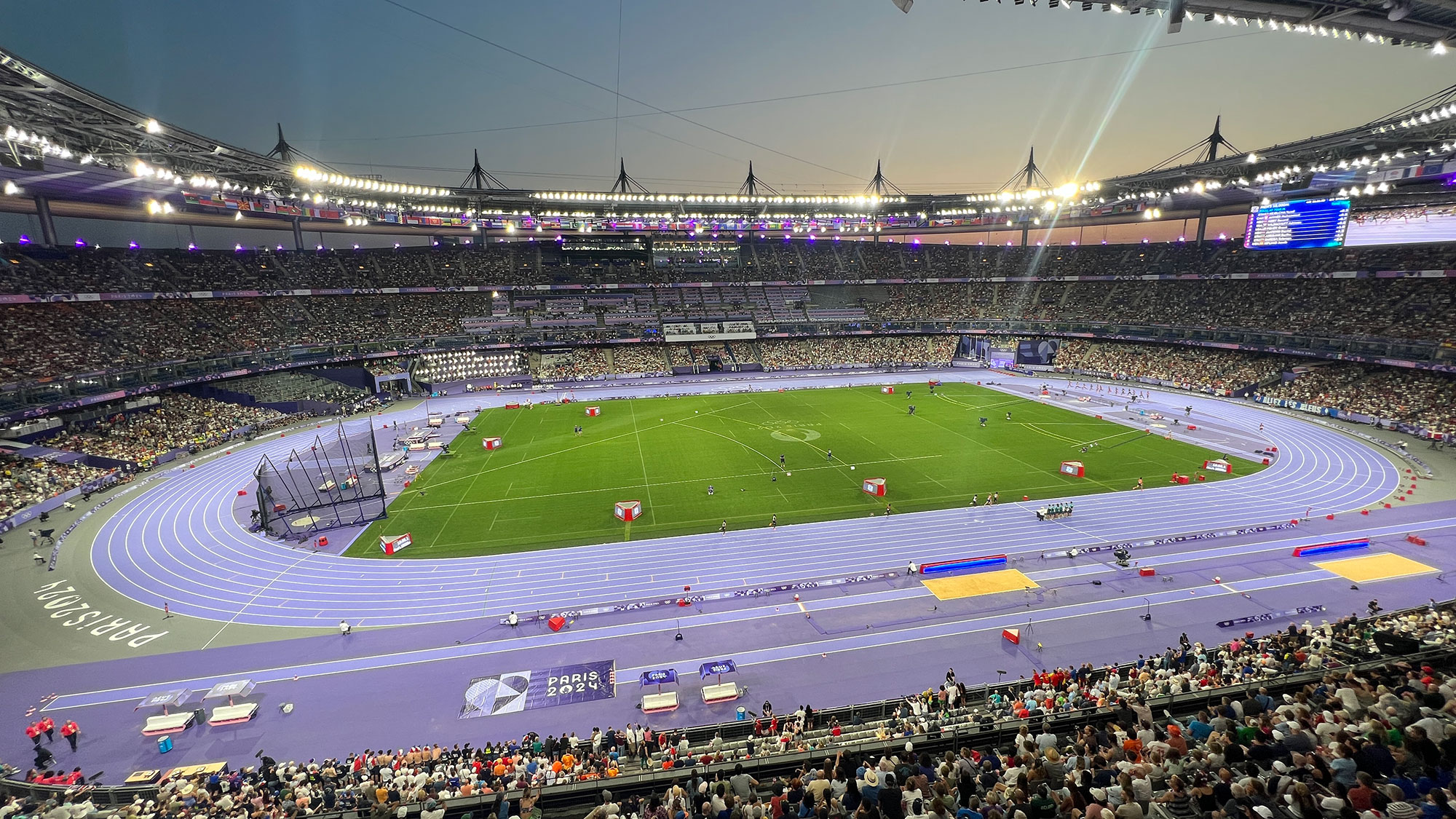 A football stadium with a field and a crowd of people.