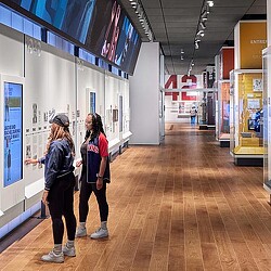 Two women interacting with Jackie Robinson Museum display