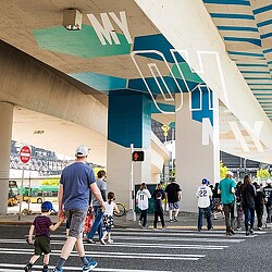 Fans walking under branded Seattle Mariners highway underpass