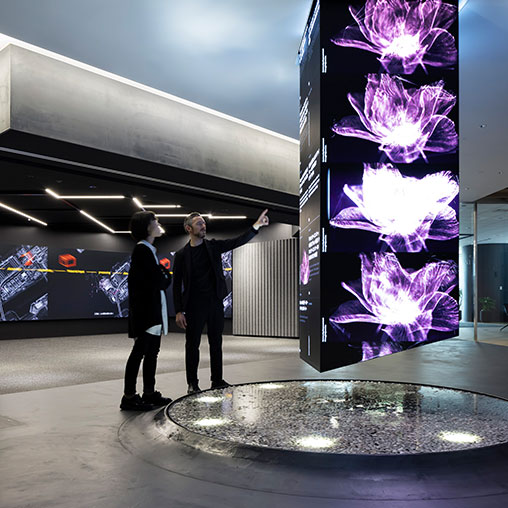 A man pointing at a large display.
