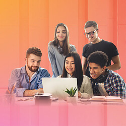 A group of people sitting at a table with a laptop.