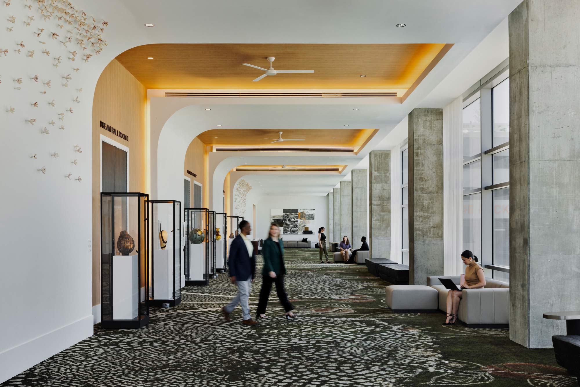 A group of people walking through a building.