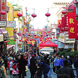 A crowd of people walking through a city.