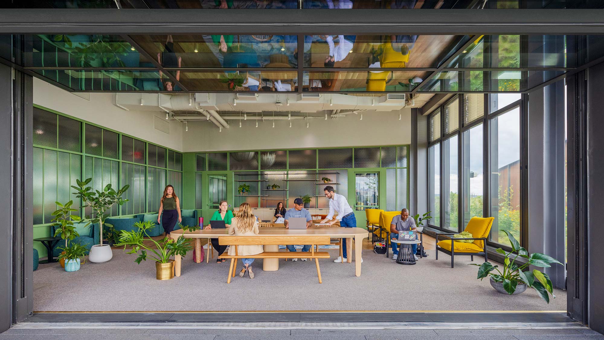 A group of people sitting at a table in a building.